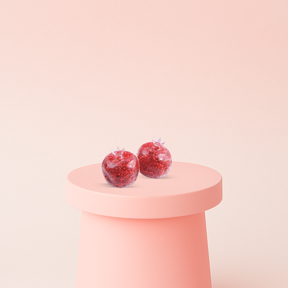 6cm Pomegranate Ball translucent red stress relief toy shaped like a pomegranate and filled with sparkling beads.