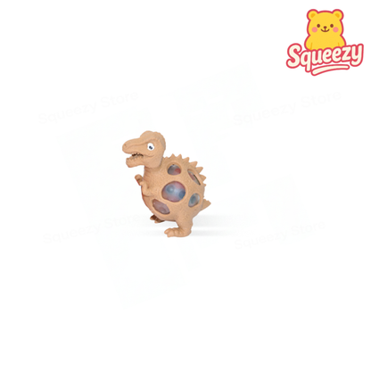 Beige Squishy Dino with Beads soft EVA stress relief toy with dinosaur spikes and visible beads.