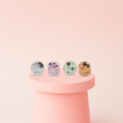 Bubble Tea Squishies collection featuring pastel mini drink cups in mint green, pink, cream, and orange colors.