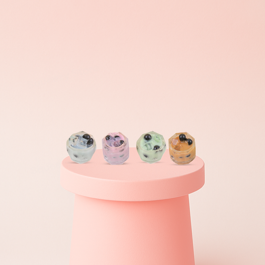 Bubble Tea Squishies collection featuring pastel mini drink cups in mint green, pink, cream, and orange colors.
