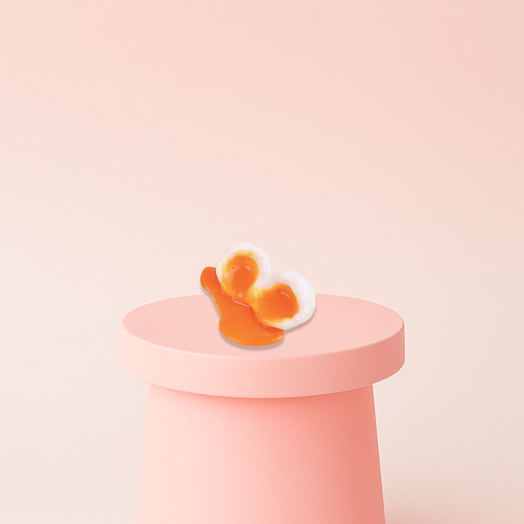 Egg Squishy shaped like a runny sunny-side-up egg with a bright orange yolk.