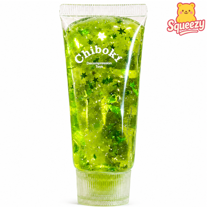 Green Chiboki sensory gel tube filled with glitter stars and sparkling transparent slime texture.