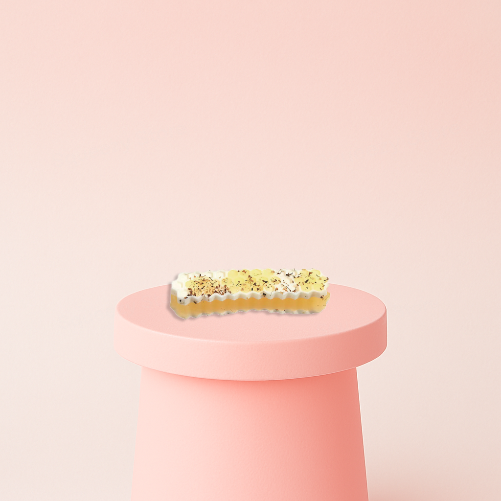 Honey Stick Squishy shaped like a golden honeycomb dessert bar topped with whipped cream and chocolate sprinkles.
