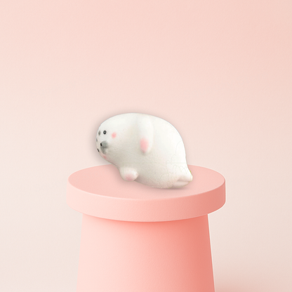Jumbo Seal Squishy displayed on a pastel stand, super soft slow-rising sensory toy for stress relief.