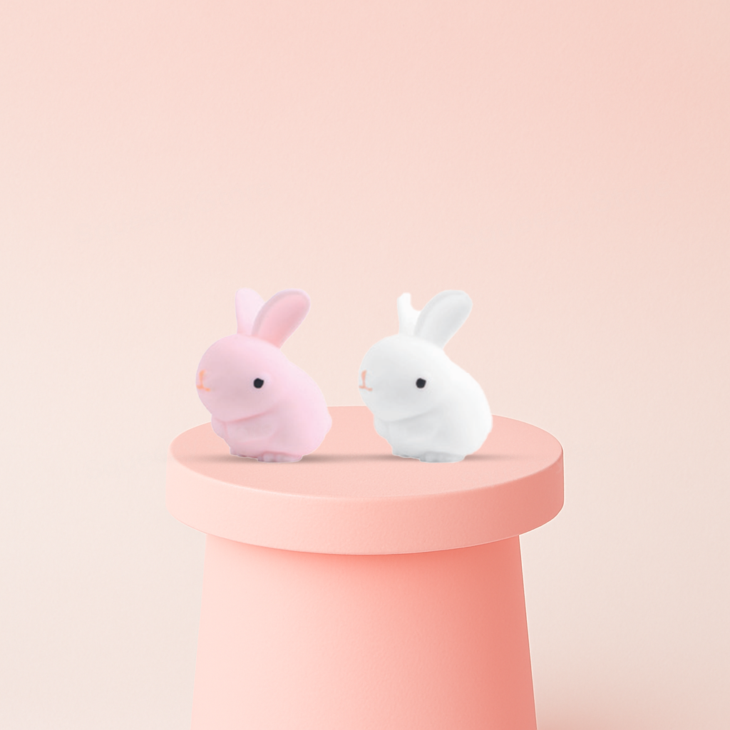 Lucky Bunny in pink and white bunny designs with long ears and round bodies.