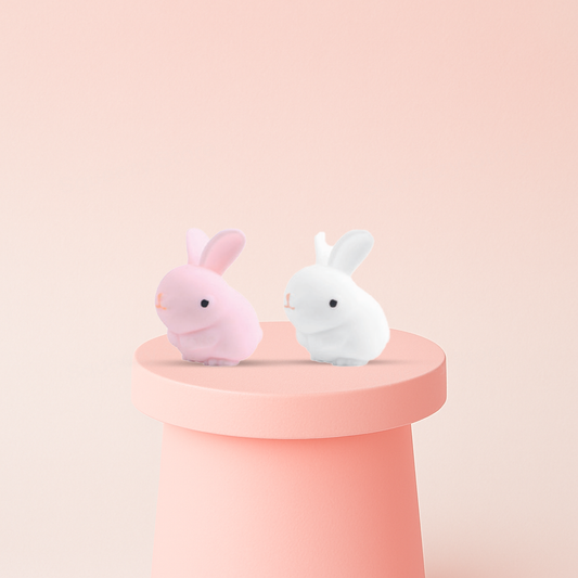 Lucky Bunny in pink and white bunny designs with long ears and round bodies.