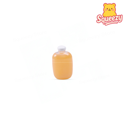 Mango Putty in a yellow-orange bottle-shaped container with mango-themed label.