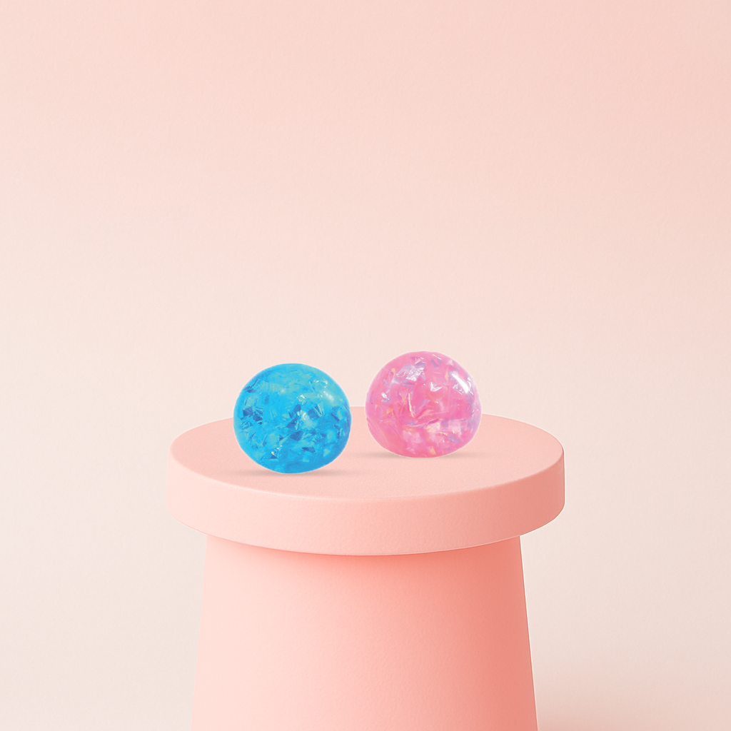 Ribbon Ball glitter stress relief balls in translucent blue and pink colors filled with shimmering ribbon confetti.
