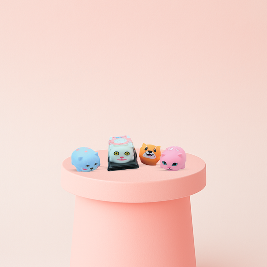 Shiba & Cat Squishies in blue, gray, orange, and pink animal designs.