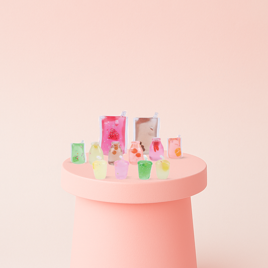 Pastel-colored drinks on a pink stand with a light pink background