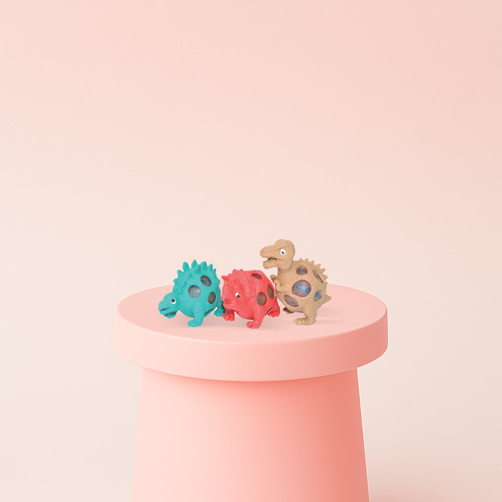Squishy Dino with Beads soft EVA stress relief toy in turquoise, red, and beige dinosaur designs.