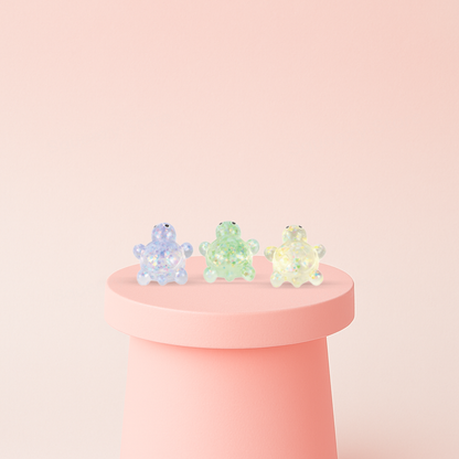 Squishy Turtle with Maltose soft EVA stress relief toys in purple, green, and yellow translucent glitter colors.