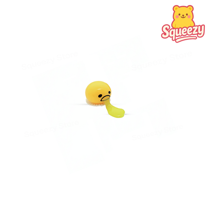 Vomiters novelty stress relief toy featuring a yellow emoji face that spits out a stretchy slime tongue when squeezed.