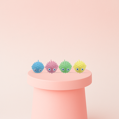 Water Splashing Fish soft EVA stress relief toy in blue, green, pink, and yellow pufferfish designs.