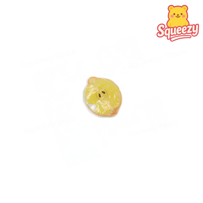 Yellow squishy toy with a bear design and 'Squeezy' branding on a white background